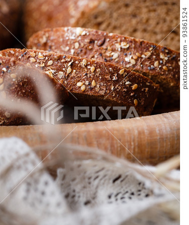 Slices of fresh wholemeal bread with baked crust and various cereals. 93861524