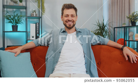 Close-up portrait of happy smiling caucasian man in shirt, looking at camera, celebrate good news 93862055