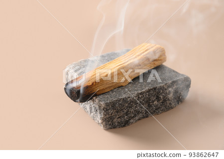 Palo Santo stick incense burning on stone. 93862647