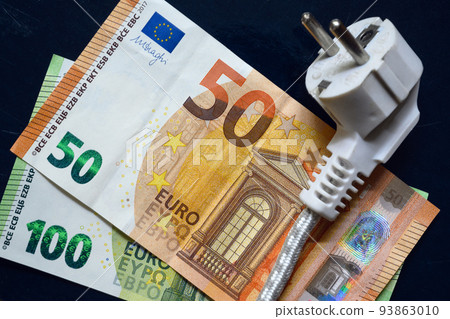 Power plug and euro money, domestic electric cable on European banknotes, top view 93863010