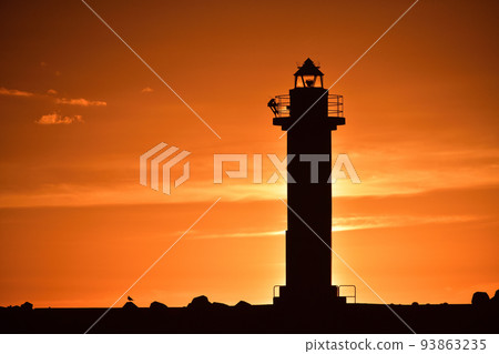 Shoot the scenery of the sunset and lighthouse at Otobe fishing port in Otobe-cho, Hokkaido in early autumn 93863235
