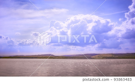 Sparkling calm river, hills and shining blue clouds and skies 93863483