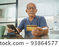 Asian Senior man making online shopping 93864577