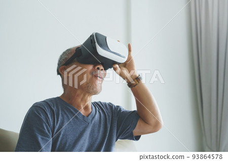 Excited Asian Senior man wearing VR goggles Excited Asian Senior man wearing VR goggles 93864578