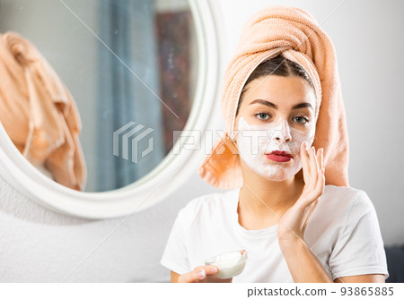 Young woman applying natural homemade facial mask 93865885