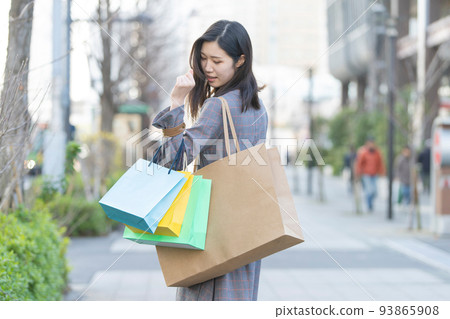 A woman holding many shopping bags 93865908