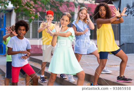 Children exercising contemporary dance moves outdoors 93865938