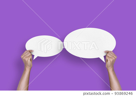 hand holding round white paper balloons speech bubbles isolated on purple background hand holding round white paper balloons speech bubbles isolated on purple background 93869246