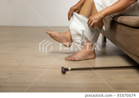 Senior man changing diaper at home. Senior man changing diaper at home. 93870874