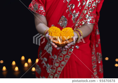 Traditional diya lamps lit during diwali celebration Traditional diya lamps lit during diwali celebration 93870878