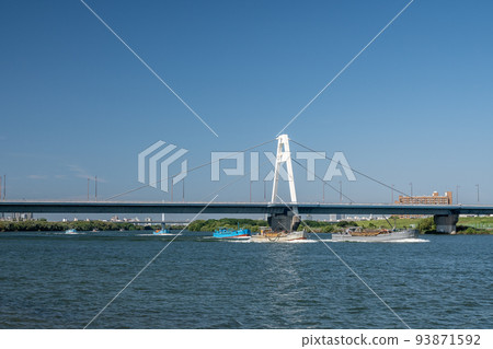 A gravel-collecting boat sailing up under the Toyosato Ohashi Bridge A gravel-collecting boat sailing up under the Toyosato Ohashi Bridge 93871592