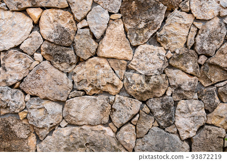 Background of limestone masonry. The surface is decorated with natural material. The wall is made of wild stone Background of limestone masonry. The surface is decorated with natural material. The wall is made of wild stone 93872219