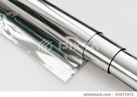 a roll of foil for baking on a white background.  93872972