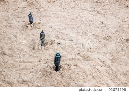hand fragmentation grenade mounted on the sand in a stretch 93873296