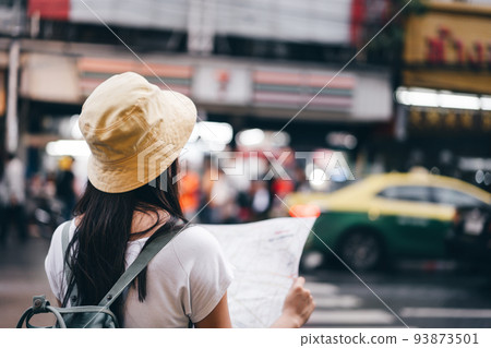 Young adult asian woman useing map when travel at Yaowarat china town. 93873501