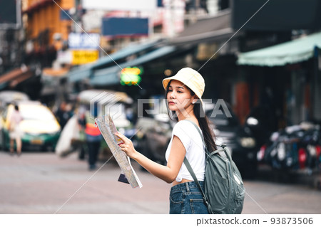 Young adult asian traveller explore searching map when sightseeing. At landmark Khaosan Young adult asian traveller explore searching map when sightseeing. At landmark Khaosan 93873506