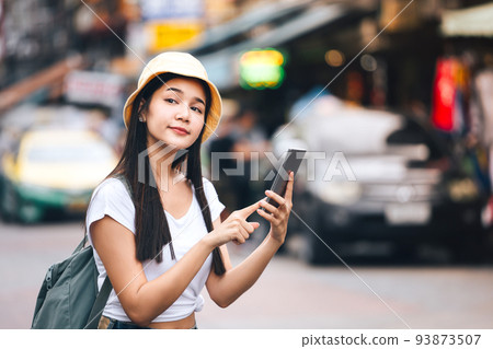 Solo woman sightseeing with modern technology use smart phone for taxi. 93873507