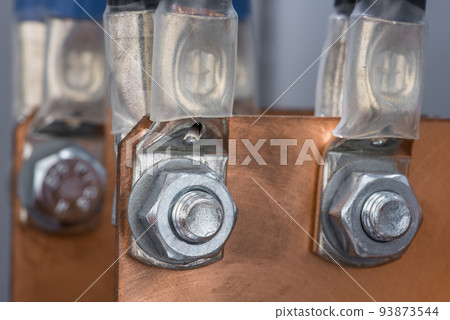 Joint of electric cable with copper bus bar by bolts and nuts in electrical power supply switchboard Joint of electric cable with copper bus bar by bolts and nuts in electrical power supply switchboard 93873544