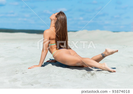 Slim woman lying on beach Slim woman lying on beach 93874018