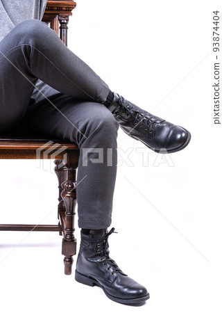 Man sitting on chair, legs close-up isolated on white background Man sitting on chair, legs close-up isolated on white background 93874404
