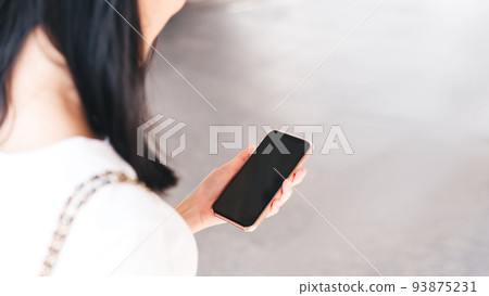 Woman hand holding a smart phone with blank screen. Woman hand holding a smart phone with blank screen. 93875231