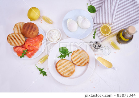 Breakfast Ingredients - Smoked salmon, poached egg and grulled buns Breakfast Ingredients - Smoked salmon, poached egg and grulled buns 93875344