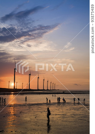 sunset view of Gaomei wetlands landscape and the wind power plant in Taichung, Taiwan. energy systems and renewable energy. 93875489