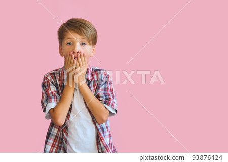 Young happy teen boy with in casuals on pink background. 93876424