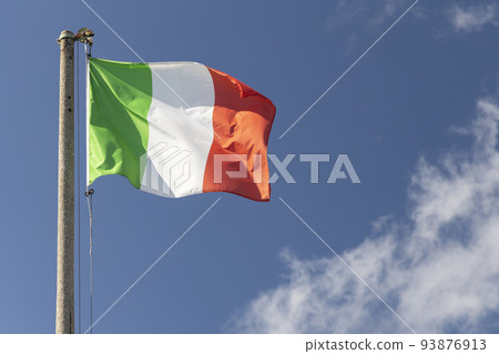 Italian flag blowing in the wind in the blue sky 93876913