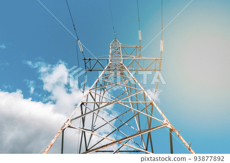 High voltage tower with electricity transmission power lines against blue sky High voltage tower with electricity transmission power lines against blue sky 93877892