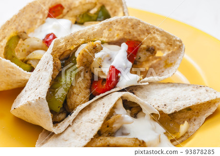 wholewheat  pitta bread filled with grilled chicken meat, jalapenos and red pepper 93878285