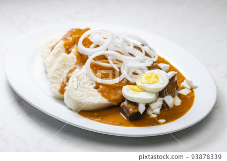 beef goulash with onion rings, boiled egg and dumplings beef goulash with onion rings, boiled egg and dumplings 93878339