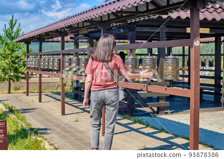 A girl spins prayer drums in the Rinpoche Bagsha datsan in Ulan-Ude city of the Republic of Buryatia, Russia. 93878386