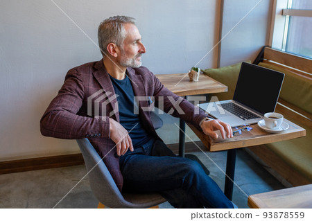 Serious pensive businessman sitting in the coffee shop 93878559
