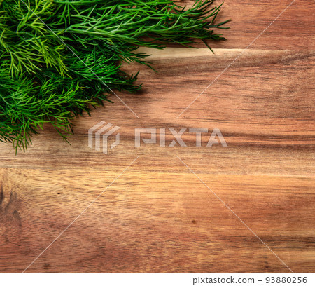 a bunch of green dill on a wooden background with blank space for text, concept of fresh vegetables and healthy food a bunch of green dill on a wooden background with blank space for text, concept of fresh vegetables and healthy food 93880256