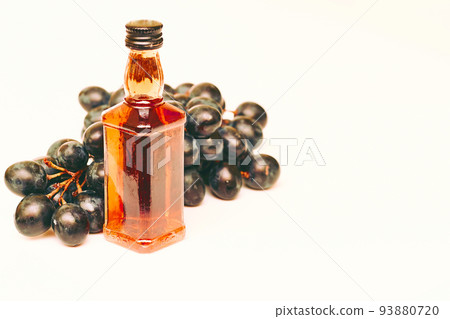 Good old brandy, cognac and black ripe grapes 93880720