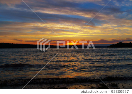 sunset over the lake, bright sun reflected in the waves, glare on the water, beautiful summer landscape sunset over the lake, bright sun reflected in the waves, glare on the water, beautiful summer landscape 93880957