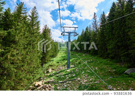 Beautiful mountains, covered with forest and open cable car line. Karpacz resort in Poland with lift road. Family outdoor recreation in mountains 93881636