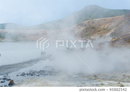 steaming hydrothermal outlet on the shore of the hot lake in the caldera of the Golovnin volcano on the island of Kunashir steaming hydrothermal outlet on the shore of the hot lake in the caldera of the Golovnin volcano on the island of Kunashir 93882542