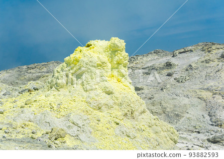 cone of sulfur deposits around a fumarole in a solfataric field against a blue sky cone of sulfur deposits around a fumarole in a solfataric field against a blue sky 93882593