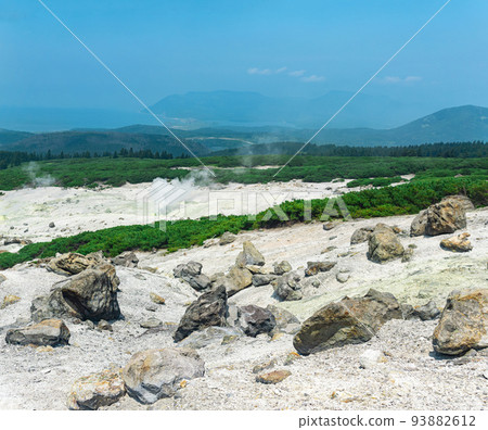 fumarole field on the slope of Mendeleev volcano on Kunashir island overlooking the ocean in the haze fumarole field on the slope of Mendeleev volcano on Kunashir island overlooking the ocean in the haze 93882612
