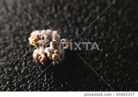 Kidney stone, intact, formed in an alkaline environment in the kidneys after ESWL intervention or surgery. Lithotripsy. Extreme macro photography. selective focus 93883157