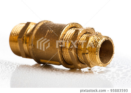 Brass fitting connection isolated on white wet table Brass fitting connection isolated on white wet table 93883593