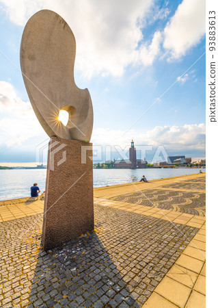 People relaxing on embankment in Stockholm 93883613