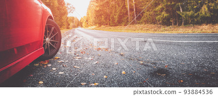 Red car on the autu asphalt road in countryside 93884536
