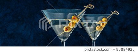 Martini, two glasses with spicy olives panorama, on a blue background 93884923