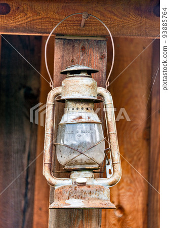Old rusty oil-lamp under the summer wooden shed 93885764