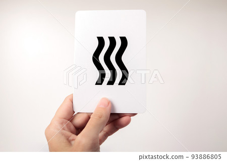 Woman's hand showing a Zener card with waves. White background 93886805