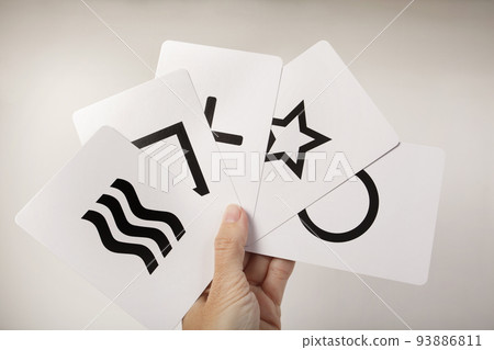 Hand fan holding the 5 Zener cards of Mentalism and Psychology. Square, circle, cross, waves and star 93886811