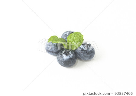 Blueberries and a mint leaf on a white background Blueberries and a mint leaf on a white background 93887466